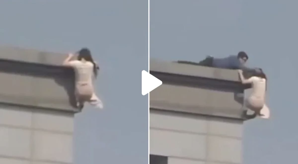 VIDEO: Policía SALVA a mujer que intentó SALTAR de edificio AGARRÁNDOLA del PELO